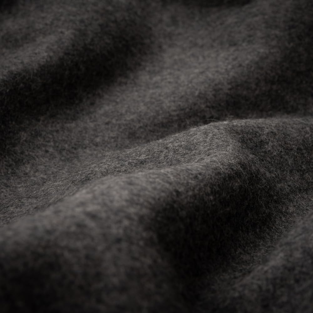 Arcturus loom-woven blanket close-up with durable contrast stitching.