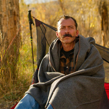 Arcturus Military Wool Blanket on couch adds cozy, durable home comfort.