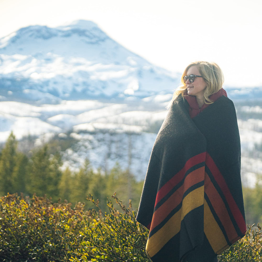 Arcturus Rainier blanket in camping scene suggests warmth on chilly nights