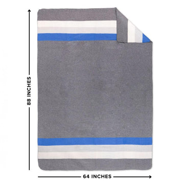 Arcturus Rainier Blanket in a woodland setting for outdoor-ready comfort.