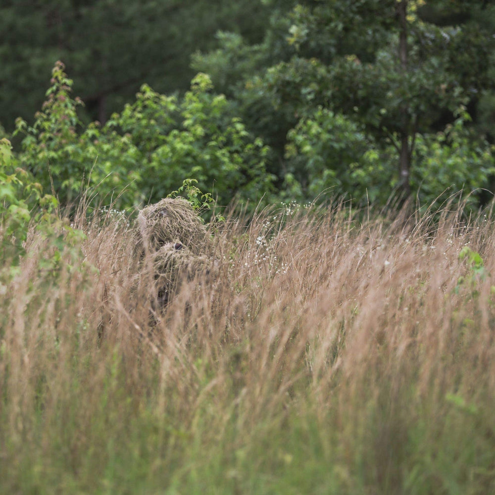 Arcturus Warrior ghillie boonie cap enhances head camouflage in tall vegetation.