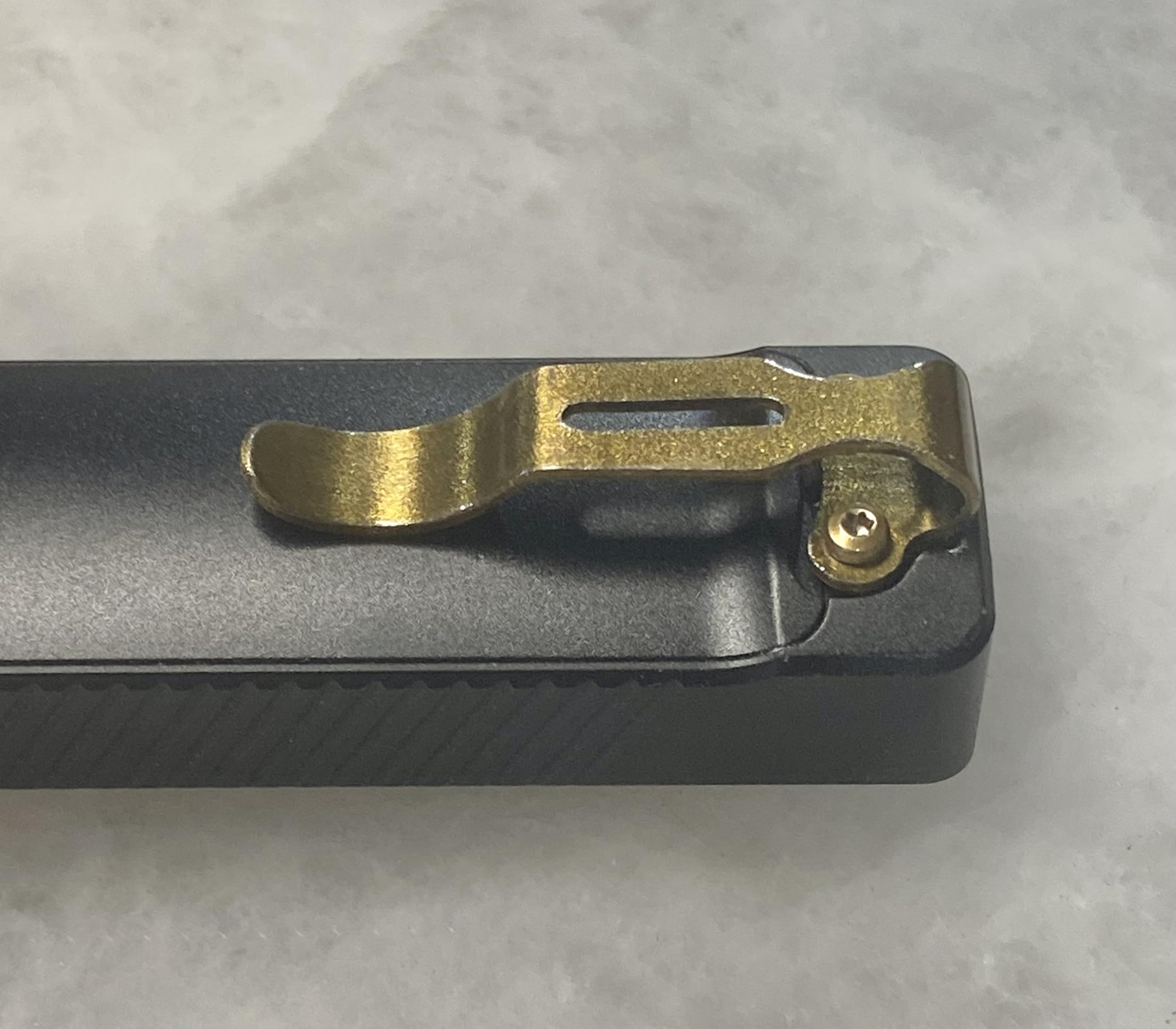 Arkfeld UV clip in golden bronze finish highlights premium EDC style
