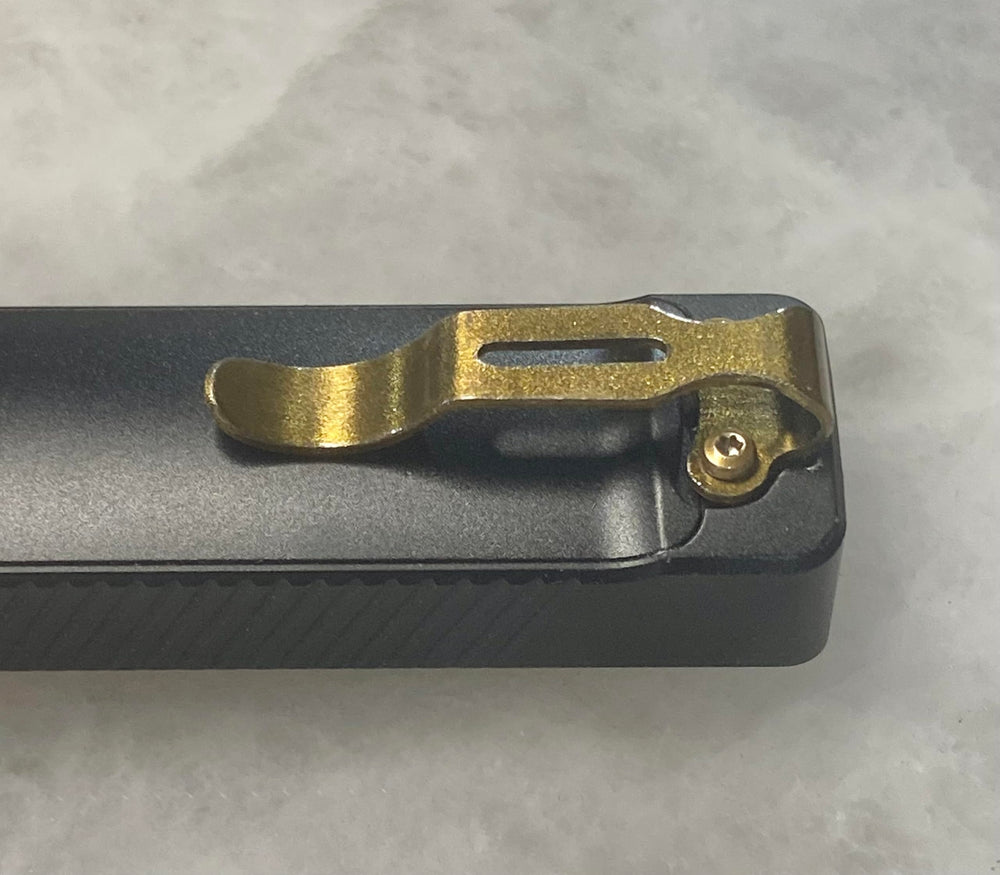 Arkfeld UV clip in golden bronze finish highlights premium EDC style