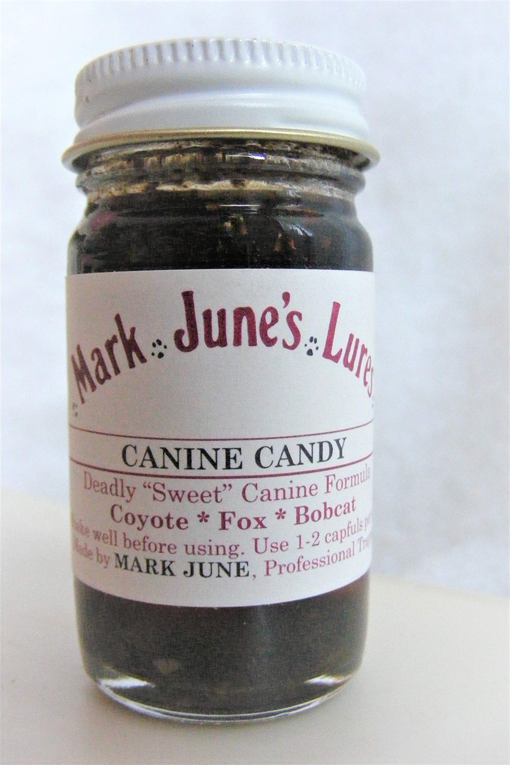 Artist Unknown Mark June's Canine Candy lure bottle for all-season canid tracking.