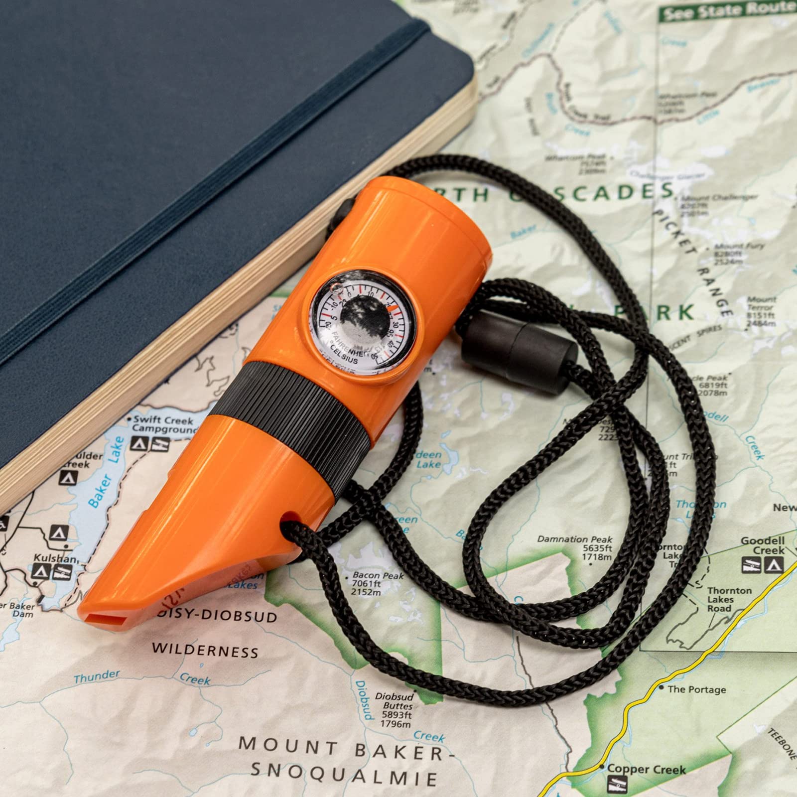 ASR Outdoor compass with integrated tool for quick forest navigation.