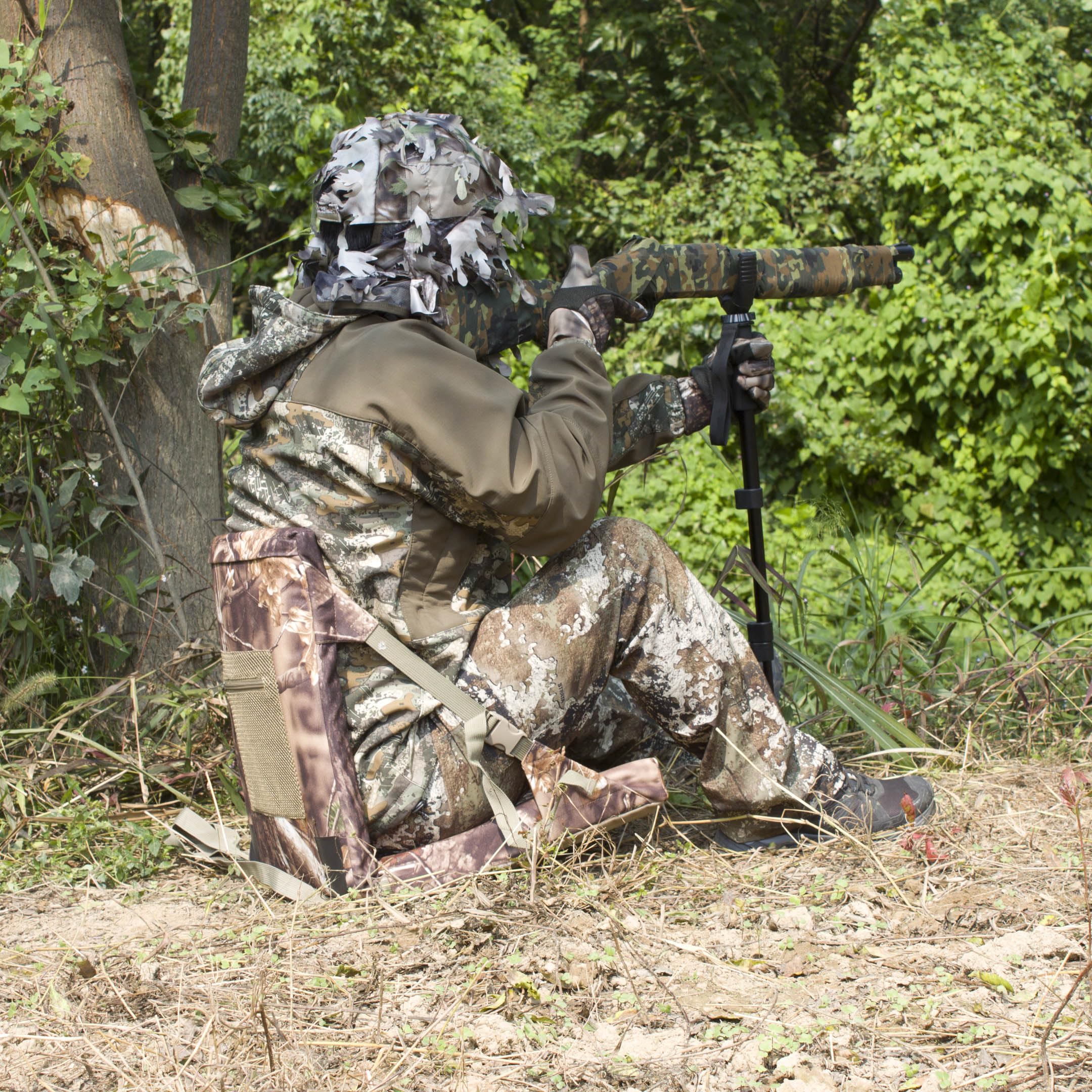 AUSCAMOTEK camouflage pattern helps concealment in woodland settings during outdoor activities.