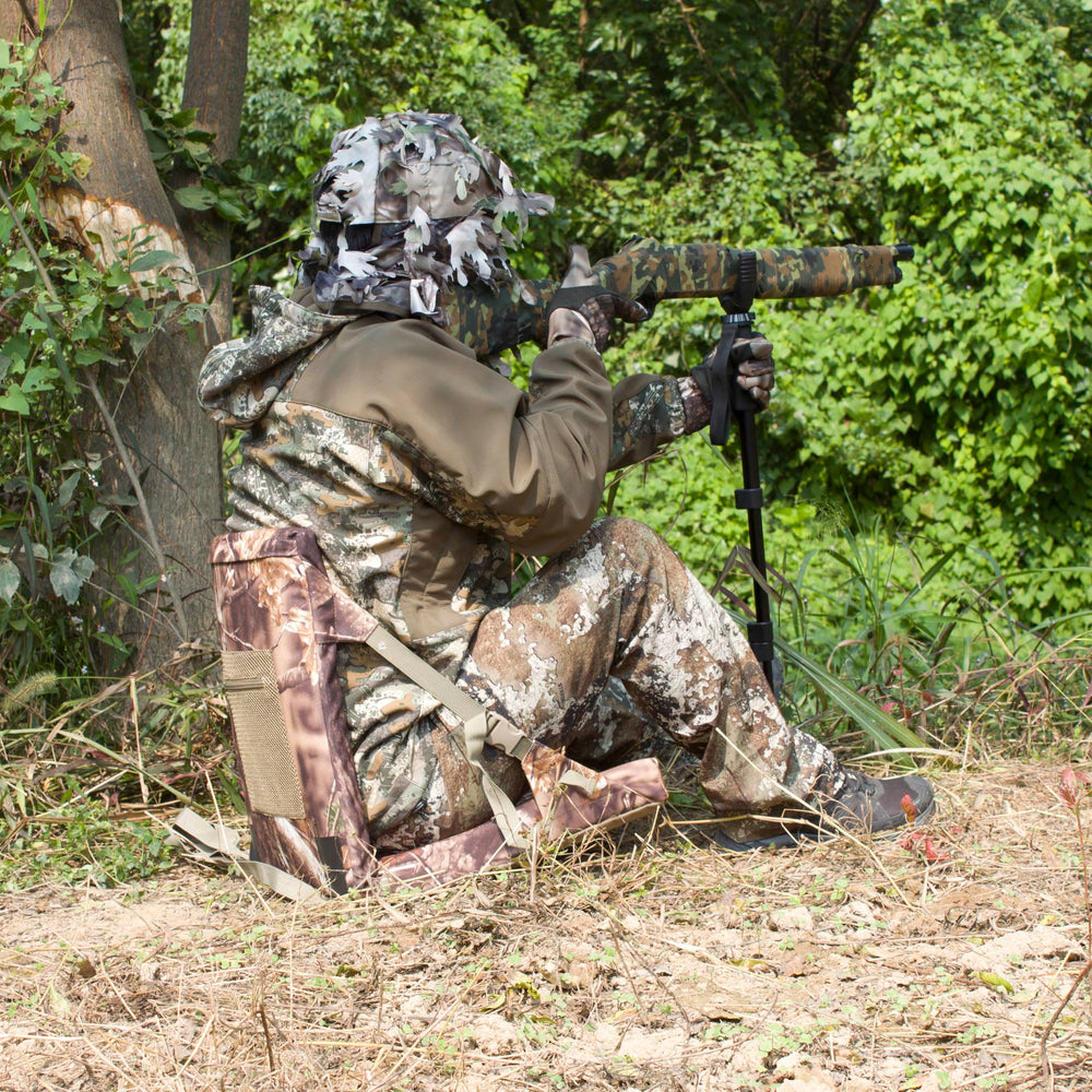 AUSCAMOTEK camouflage pattern helps concealment in woodland settings during outdoor activities.