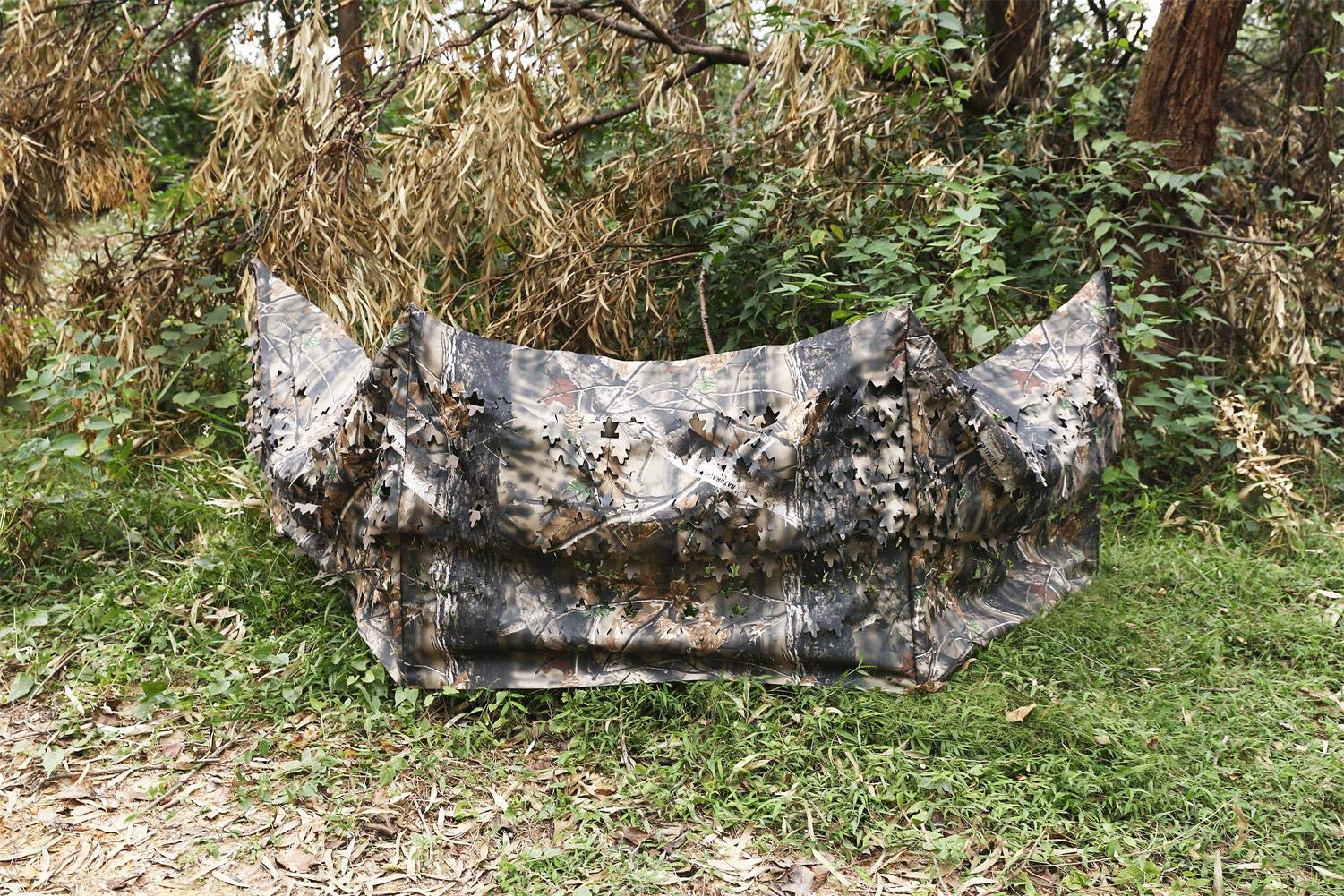 Auscamotek ground blind in woodland brown leaf pattern blends into autumn landscapes for deer and turkey hunting.