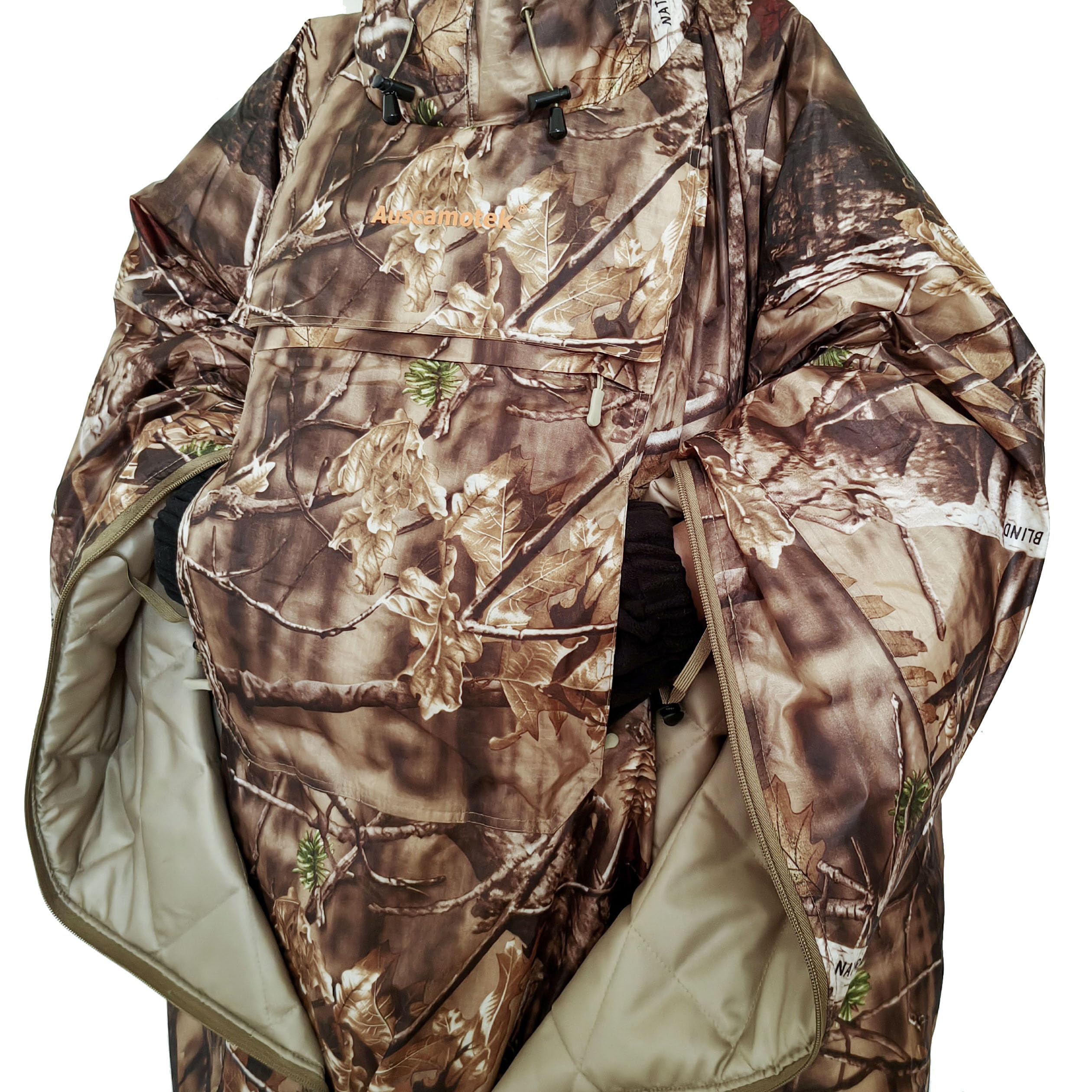AUSCAMOTEK woodland camo hunting poncho blends into forest brush for concealment.