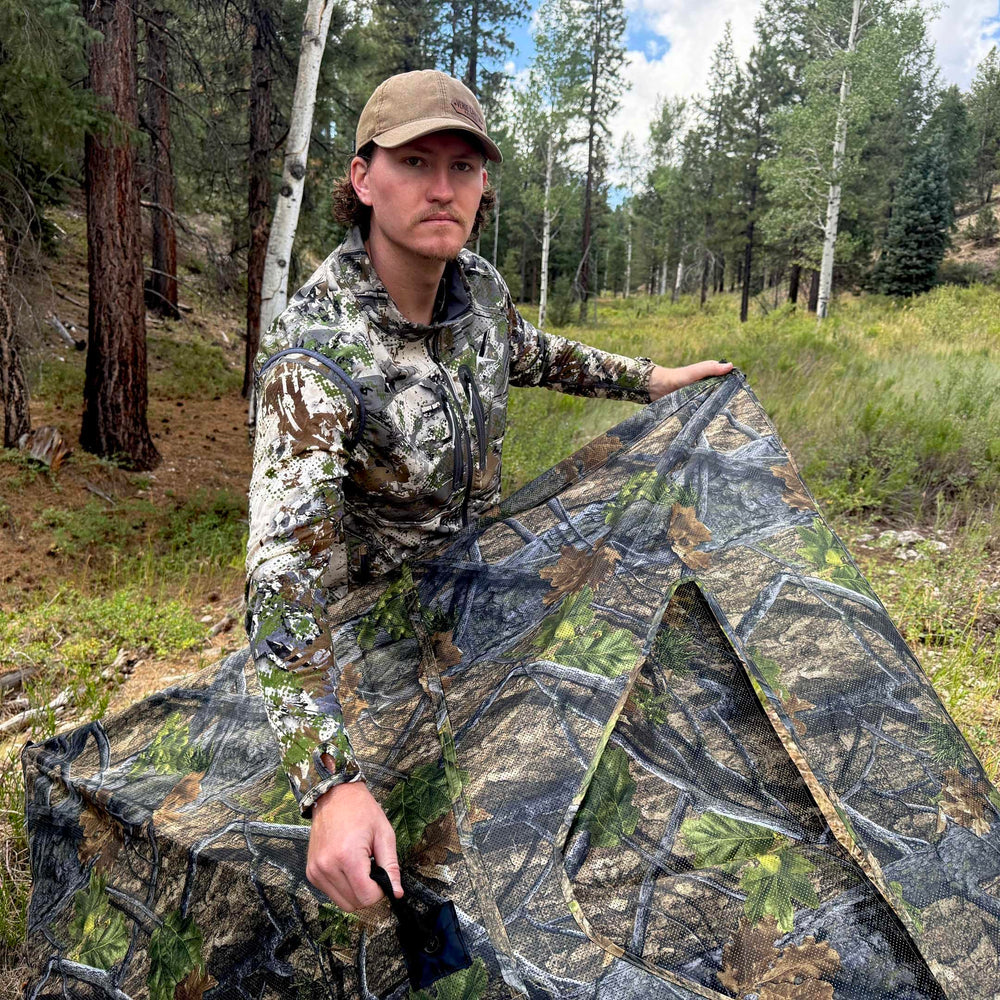 AUSCAMOTEK woodland concealment in dense cover supports deer and turkey hunts.
