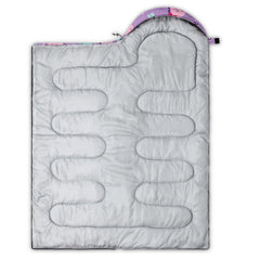 Axolotl pink purple dinosaur sleeping bag folded in compression sack for easy travel.