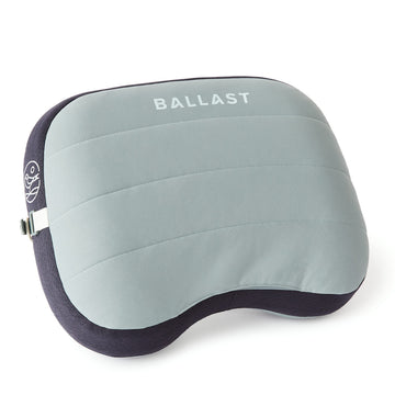 Ballast Beach Pillow inflated on sand provides portable beach comfort.