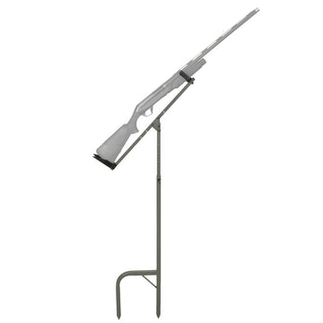 Banded Gun Stick Hands-Free Holder in muddy terrain securing a shotgun for hands-free use