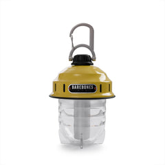 Barebones Beacon Hanging Light dusty yellow at campsite delivering warm outdoor meals