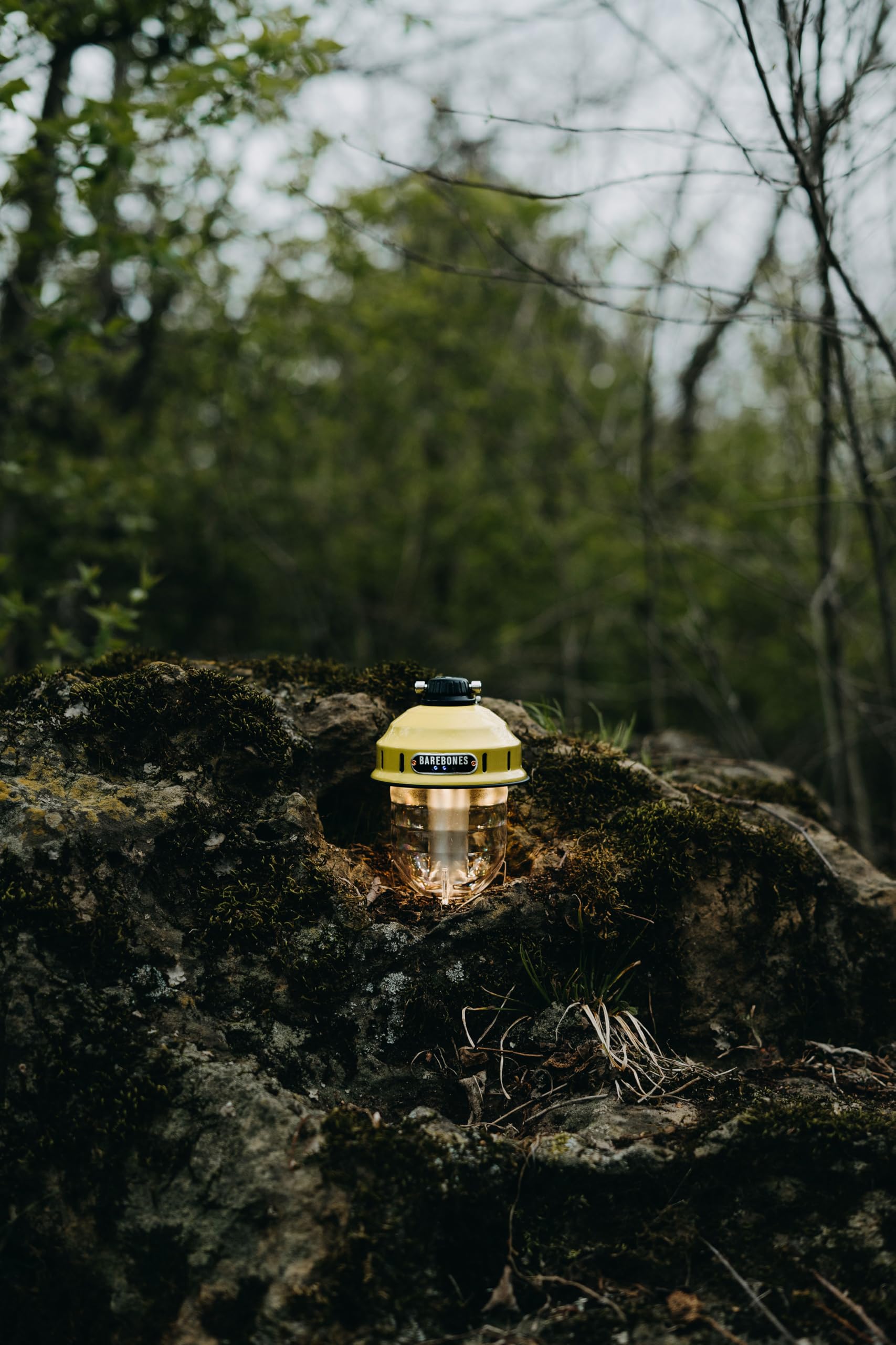 Barebones Beacon Hanging Light dusty yellow glow on porch for cozy evenings