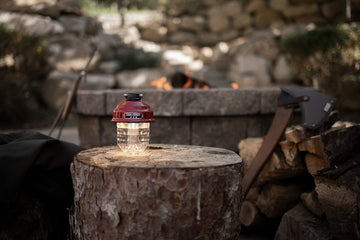 Barebones Beacon hanging light red brightness-adjustment provides customizable lighting for camping dinners.