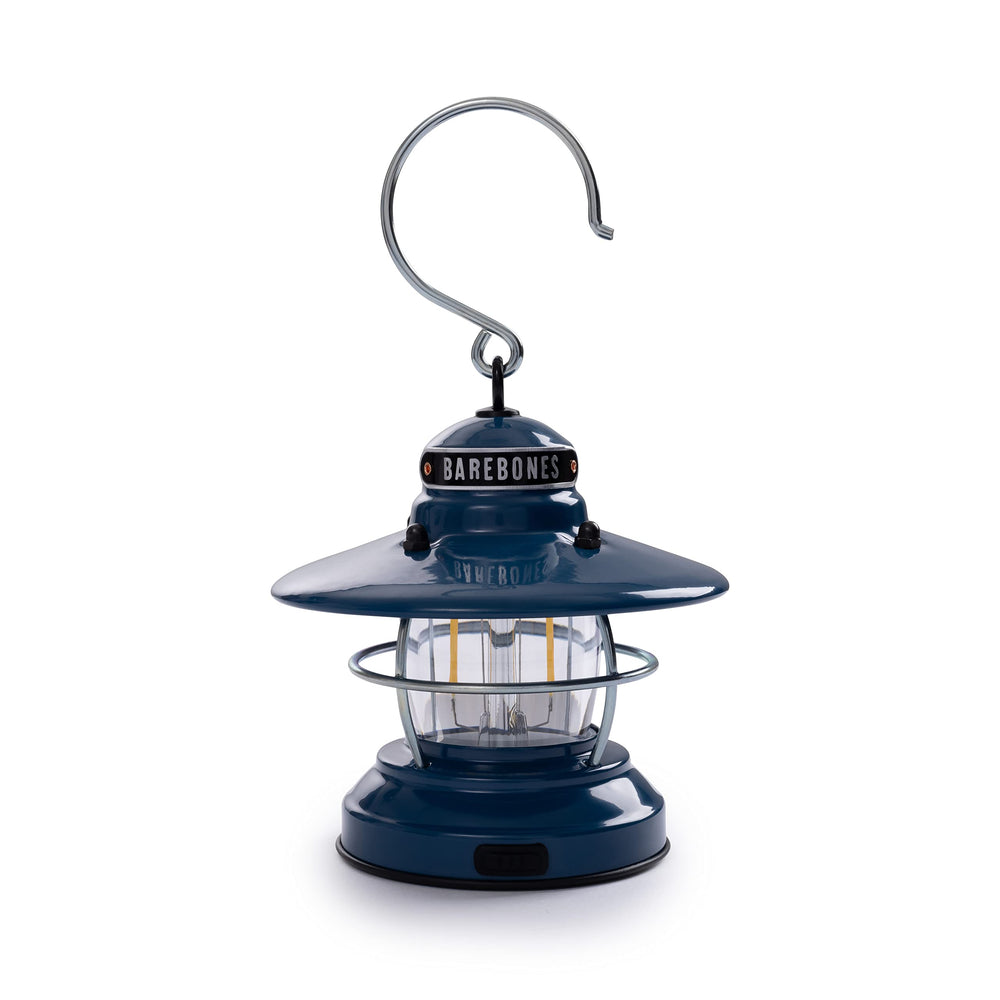 Barebones Edison Mini Lantern in ocean blue on table for cozy camping ambiance.