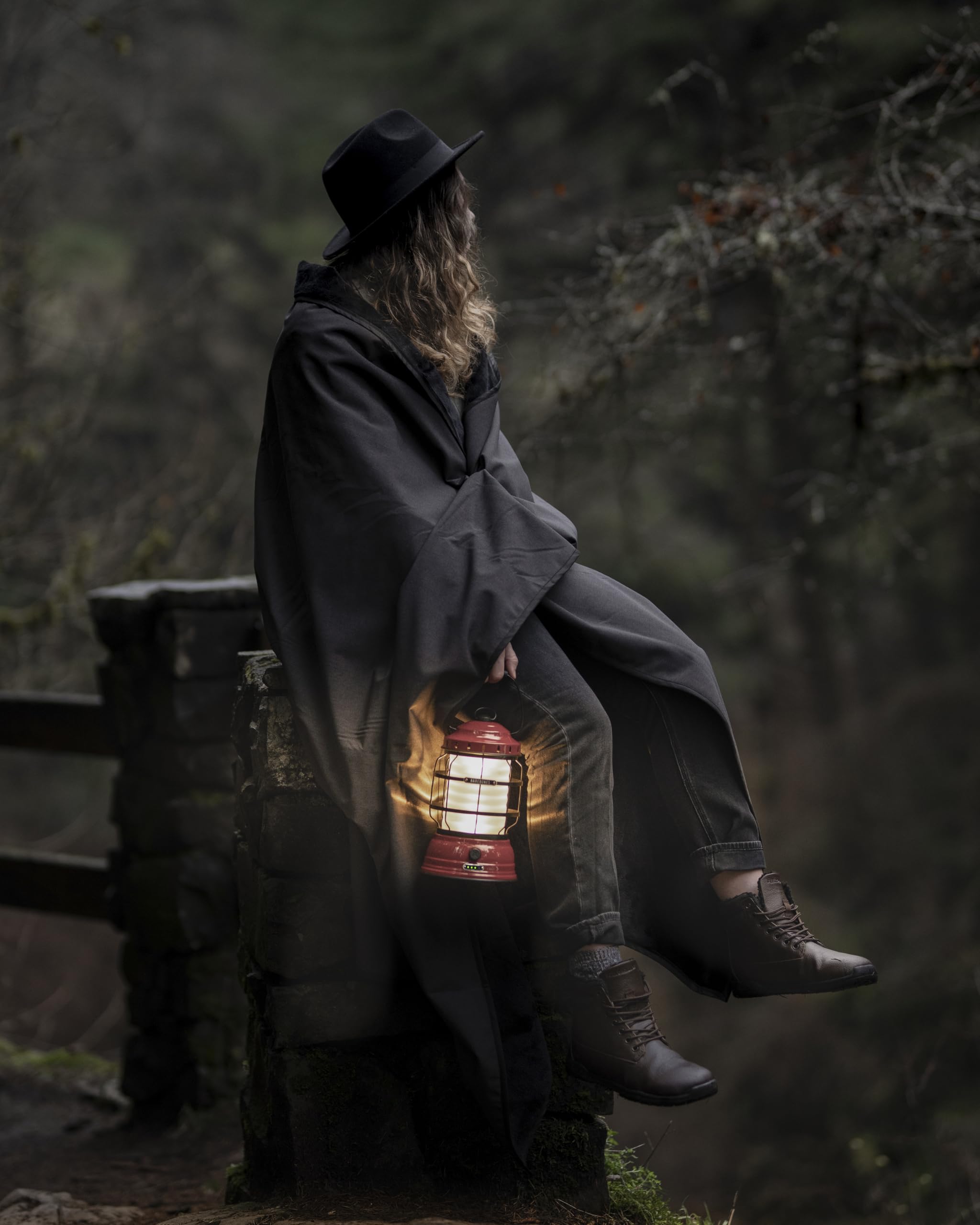 Barebones Forest Lantern red in camping-kitchen setup illustrates cozy ambient light.