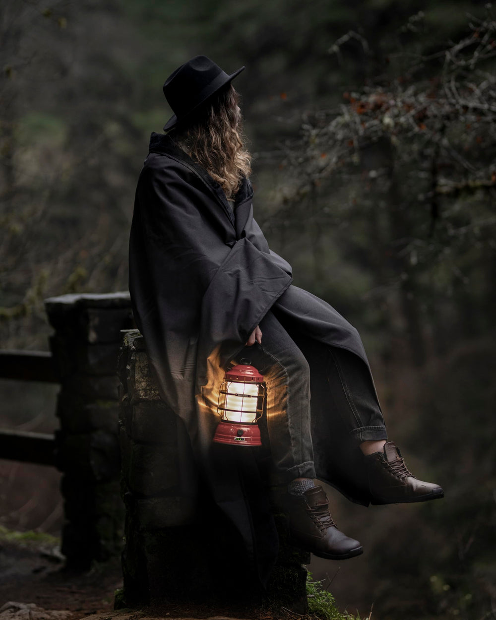 Barebones Forest Lantern red in camping-kitchen setup illustrates cozy ambient light.
