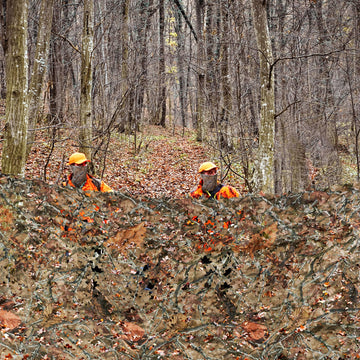BASSDASH camo netting with storage bag and hanging setup for portable use.