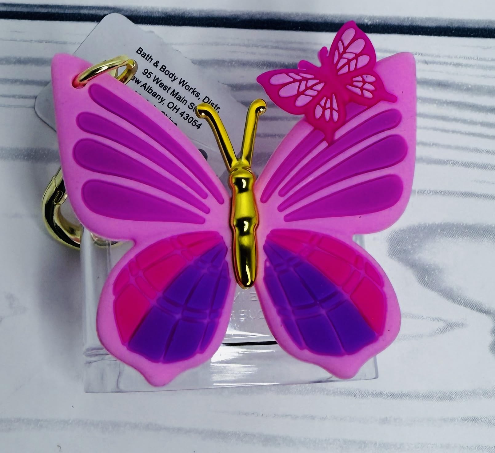Gold-tone clip detail on Bath and Body Works PocketBac Holder for secure bag attachment.
