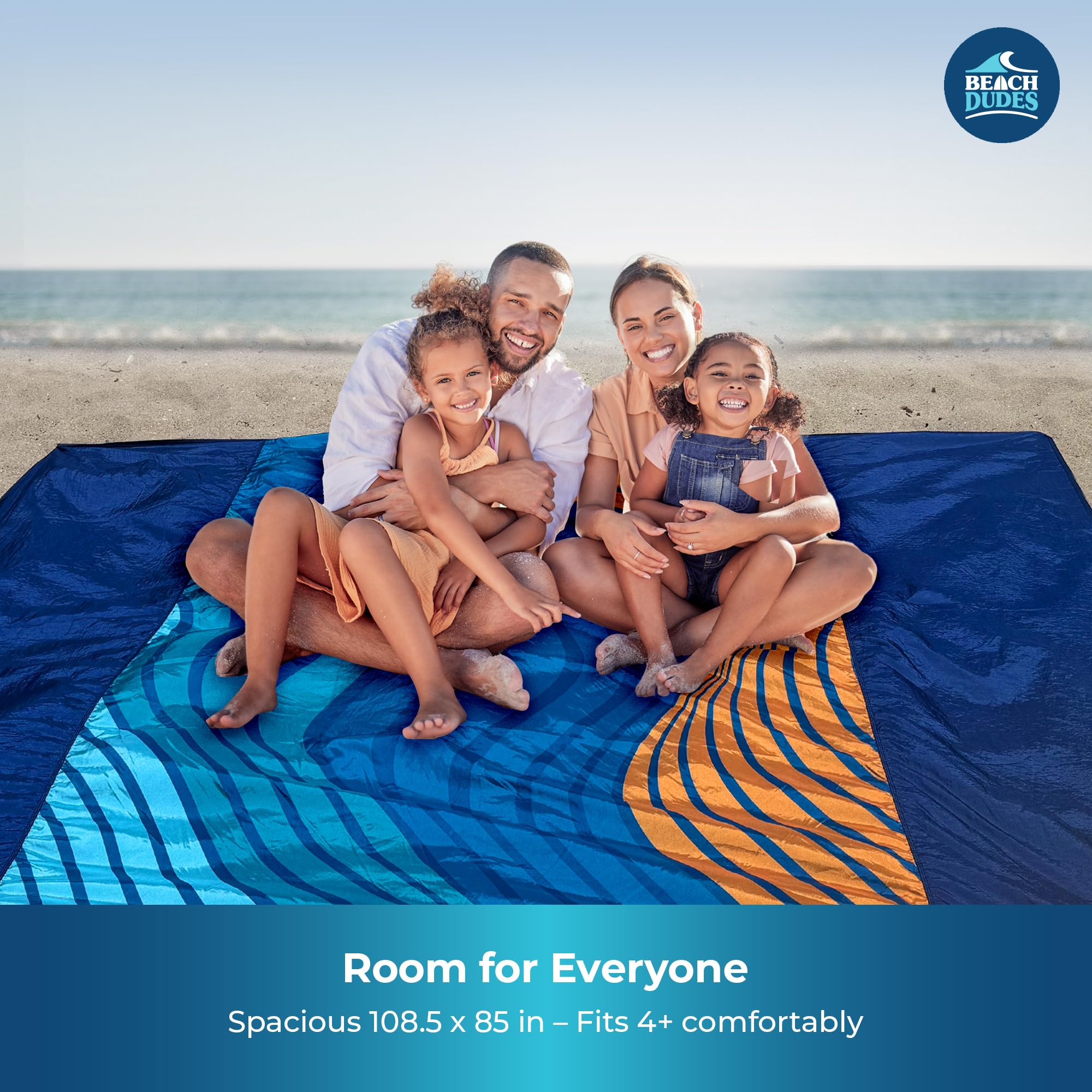 Beach Dudes Blue Waves blanket with stakes in use, wind-secure on breezy days.