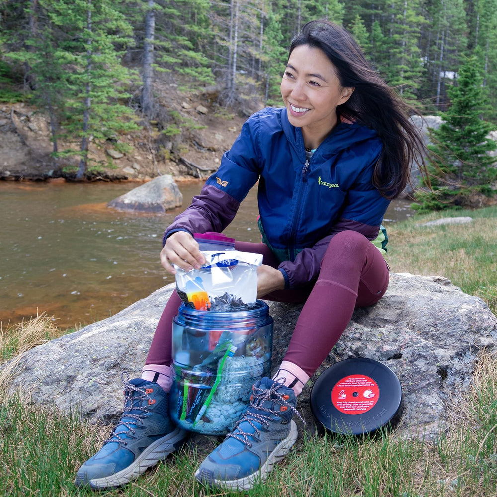 BearVault BV475 Trek strapped on pack illustrates secure top-tie capability.