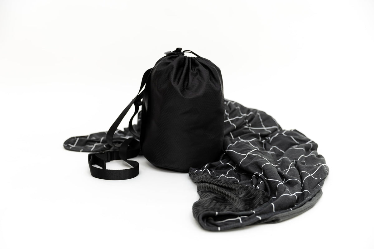 Beddy's dual-sided travel blanket in bag for portable comfort on the go