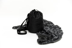 Beddy's dual-sided travel blanket in bag for portable comfort on the go