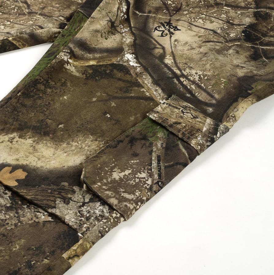Bell Rangers Realtree APX camo pants fabric close-up highlighting moisture-wicking, breathable cotton-poly blend.