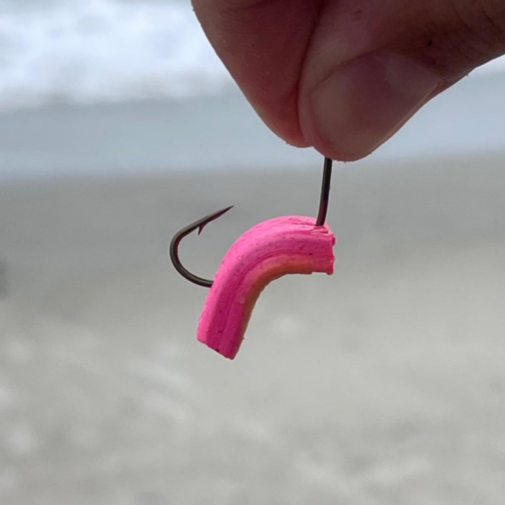 Berkley Gulp! Surf Bytes Strips chartreuse portrayed as long-lasting bait for coastal fishing.