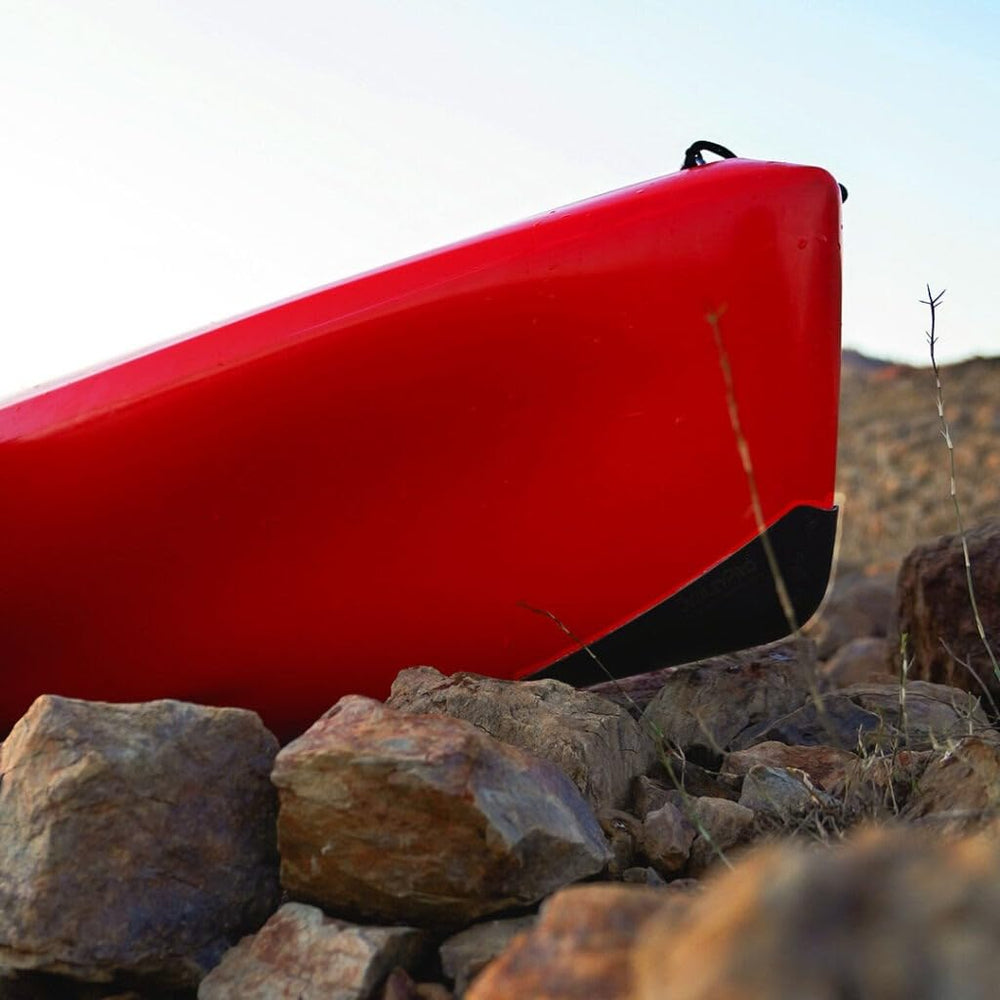 Front guard installed on kayak enhances hull protection during launches and shore contact.