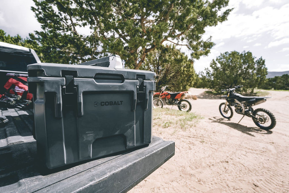 Blue Coolers Cobalt 25qt anti-skid feet stabilize on uneven surfaces.