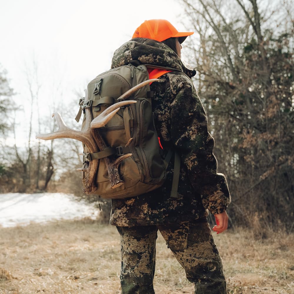 BOG Prevail Day Pack retractable bottle pocket in use with a 32 oz bottle