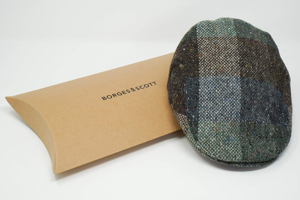 Galway patchwork tweed cap worn outdoors during coastal walk