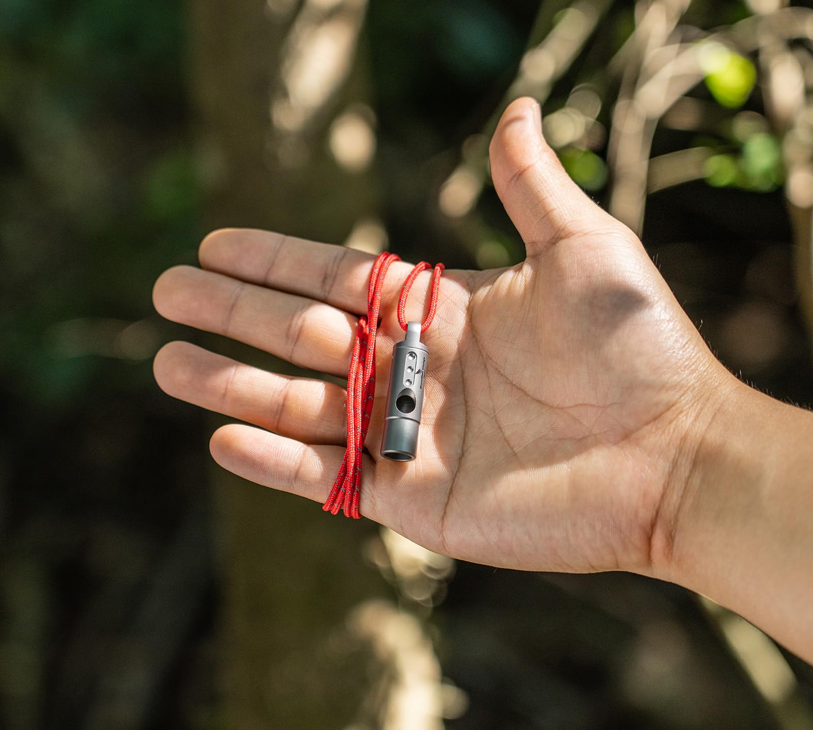 Boundless Voyage Ti9016 with woven rope for easy neck carry during outdoor activities.