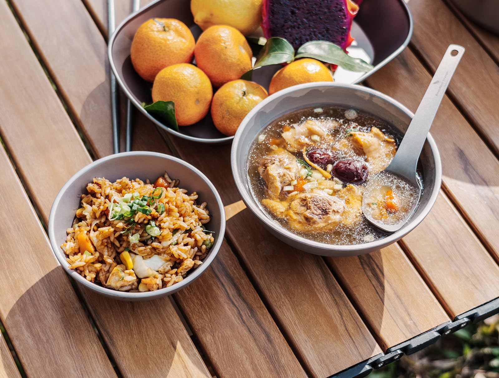 Boundless Voyage titanium bowl double-wall hands view emphasizes heat-protective capability.