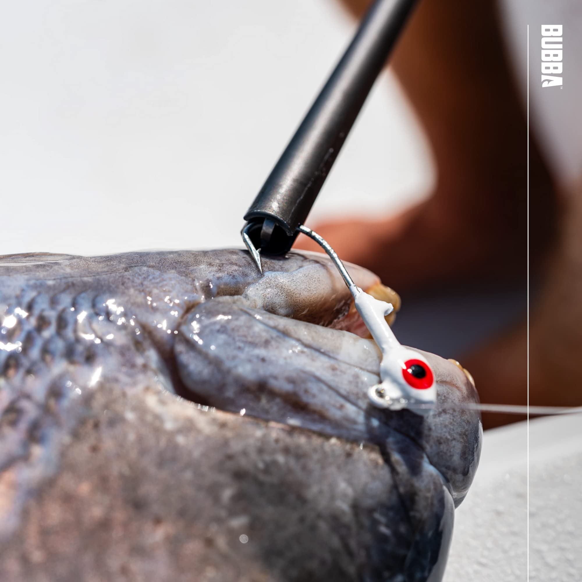 BUBBA hook extractor during use near pike illustrates hand protection.
