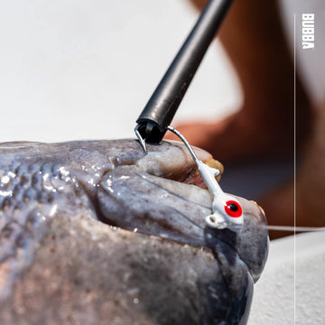 BUBBA hook extractor during use near pike illustrates hand protection.