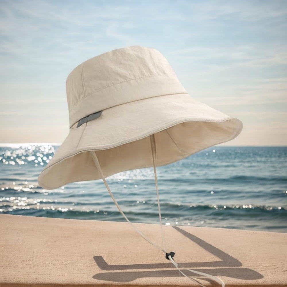 Beige bucket hat with adjustable chin strap for outdoor activities