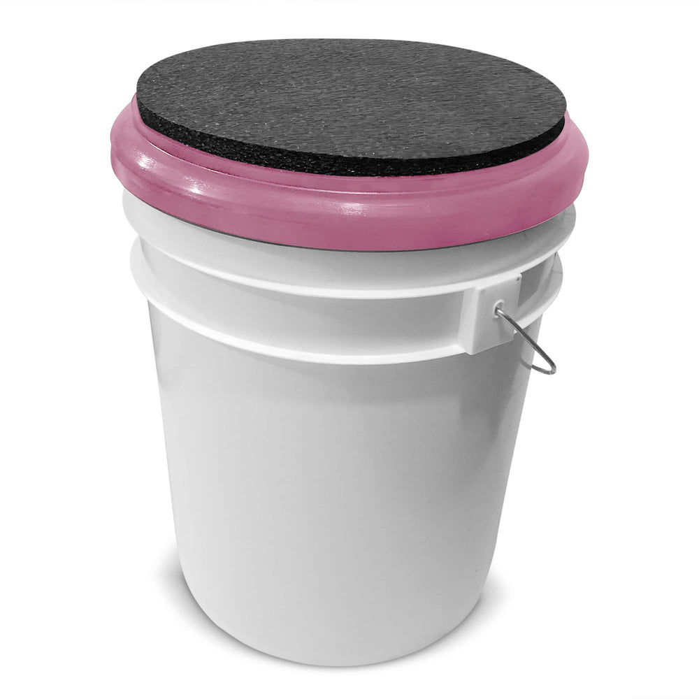 BUCKET PROS pink bucket lid seat with black pad close-up shows cushioned surface.