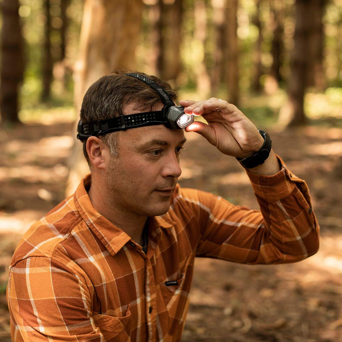Bushnell TRKR 325L headlamp side controls for easy one-handed operation.