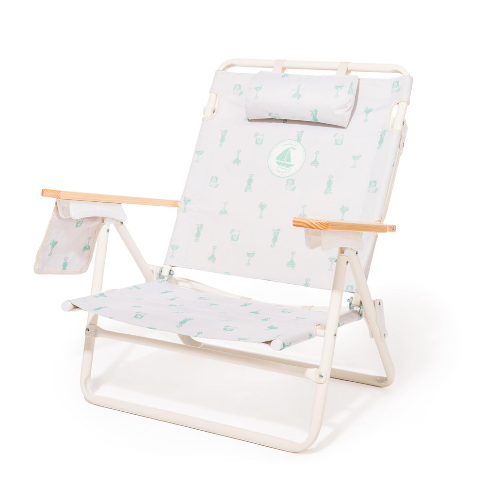 Business & Pleasure Co. Margaritaville Manana backpack chair in recline mode for beach comfort.