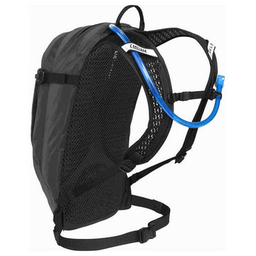 CamelBak Women's M.U.L.E. 12 helmet carry demonstrates secure gear transport during MTB sessions.