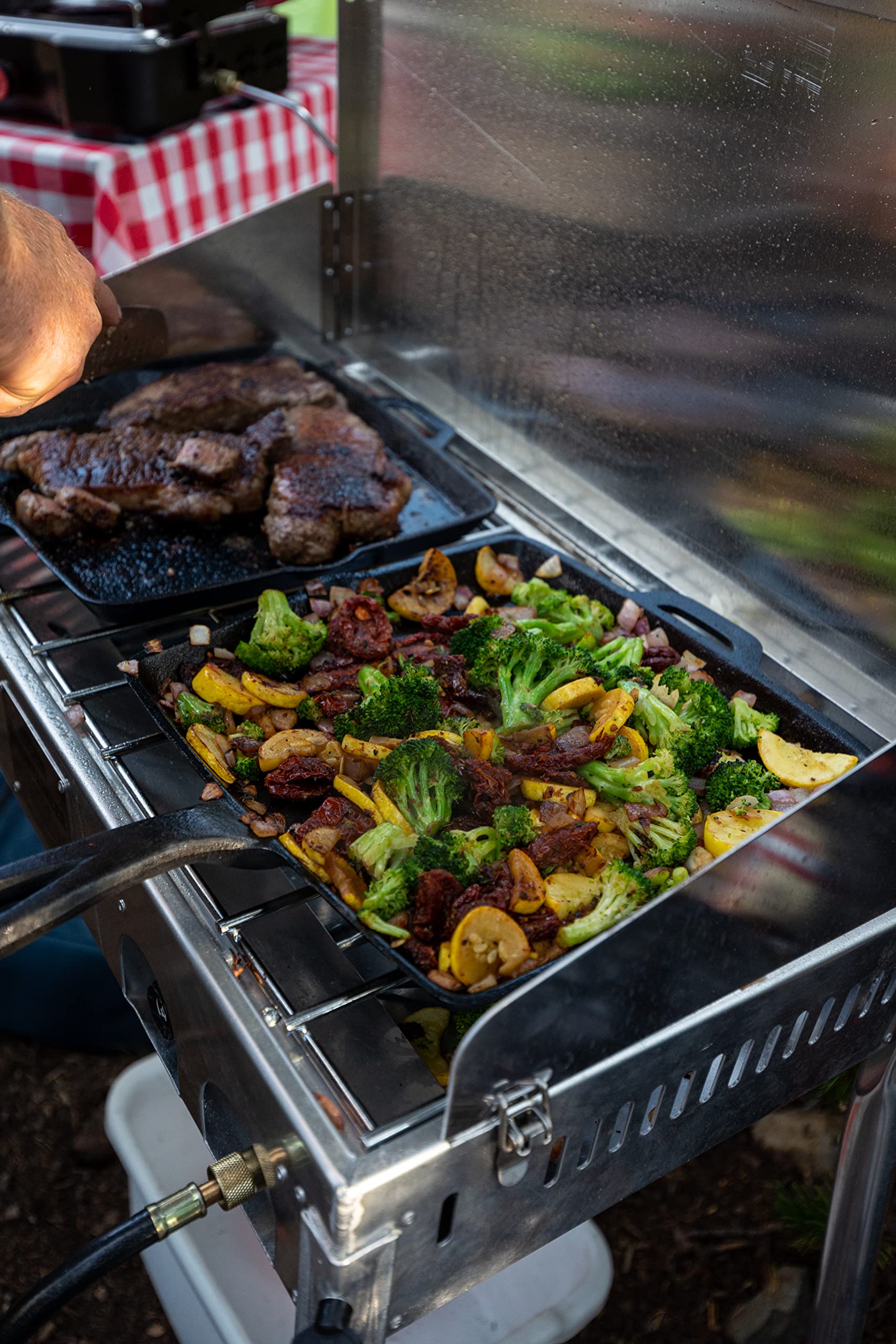Camp Chef Mountaineer lid folds for transport and wind protection during use.