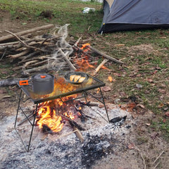 CAMPMAX heavy-duty steel campfire grill top withstands heat during camp meals.