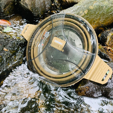 CAMPWOLF collapsible pot lid with strainer for draining liquids at campsite.