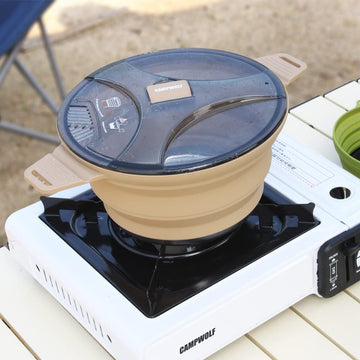 CAMPWOLF khaki camping pot ready for deployment in a camping setup.