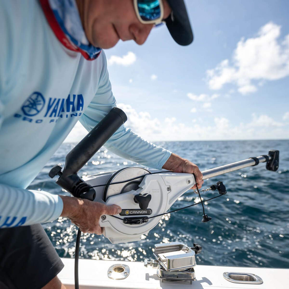Cannon downrigger base mounted on boat highlights stable trolling setup.