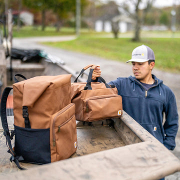 Carhartt Thick Foam Cold Front cooler includes bottle opener for beverages.